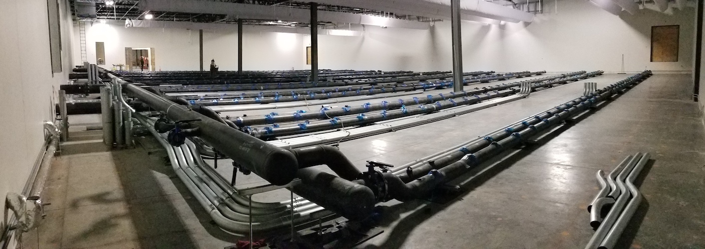 Underfloor piping is laid inside the data centre for the DUG Cool system feeding the first four rows our tanks