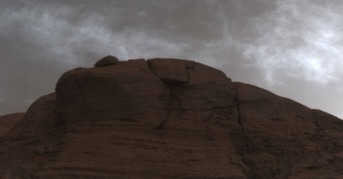 Curiosity over colourful clouds on Mars.